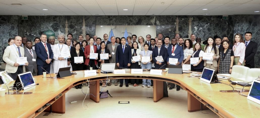 Recognised innovators holding their certificates behind a curved conference table at the FAO conference